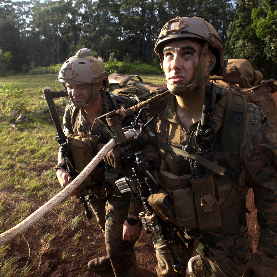 U.S. Marines in camouflage with SPIE rope over their shoulders, fully equipped and waiting for extraction, demonstrating readiness and versatility.  (8745383624941)