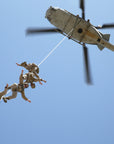 U.S. Marines suspended on a SPIE rope under a helicopter, demonstrating a fast and efficient extraction operation in action. (8745383624941)