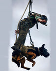 U.S. Marine and military working dog tandem on a SPIE line under a helicopter, showing the SPIE system's ability to safely extract both personnel and animals.  (8745383624941)