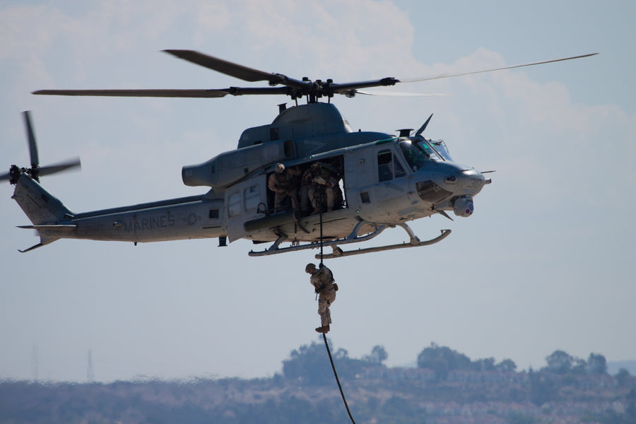 U.S. Marine fast roping from a helicopter using a Ravenox Military Fast Rope, demonstrating safe and efficient descent. (8745128526061)